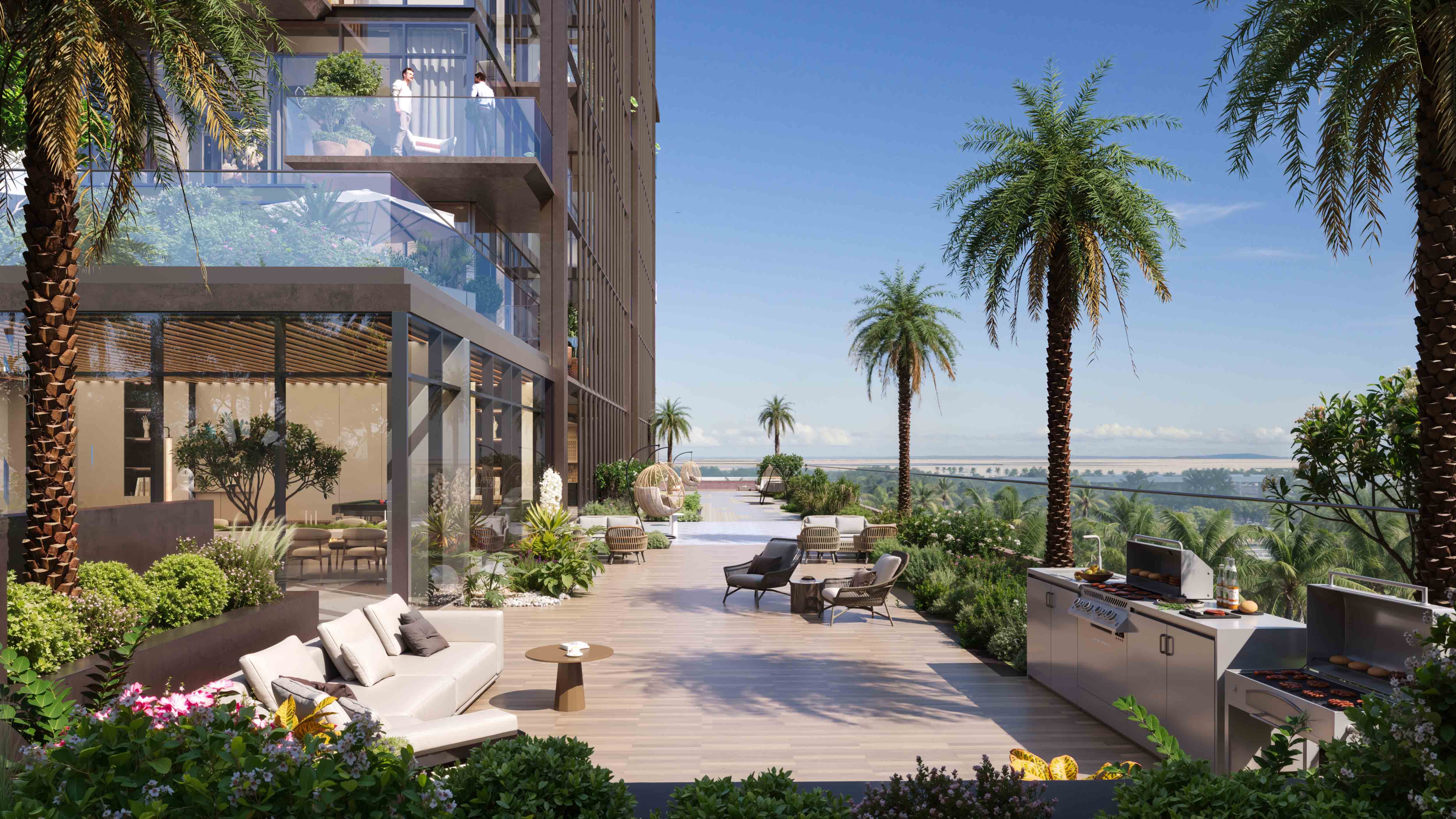 Wynwood Horizon By Imtiaz A spacious outdoor patio with modern seating, palm trees, greenery, and a barbecue station overlooking a serene view.